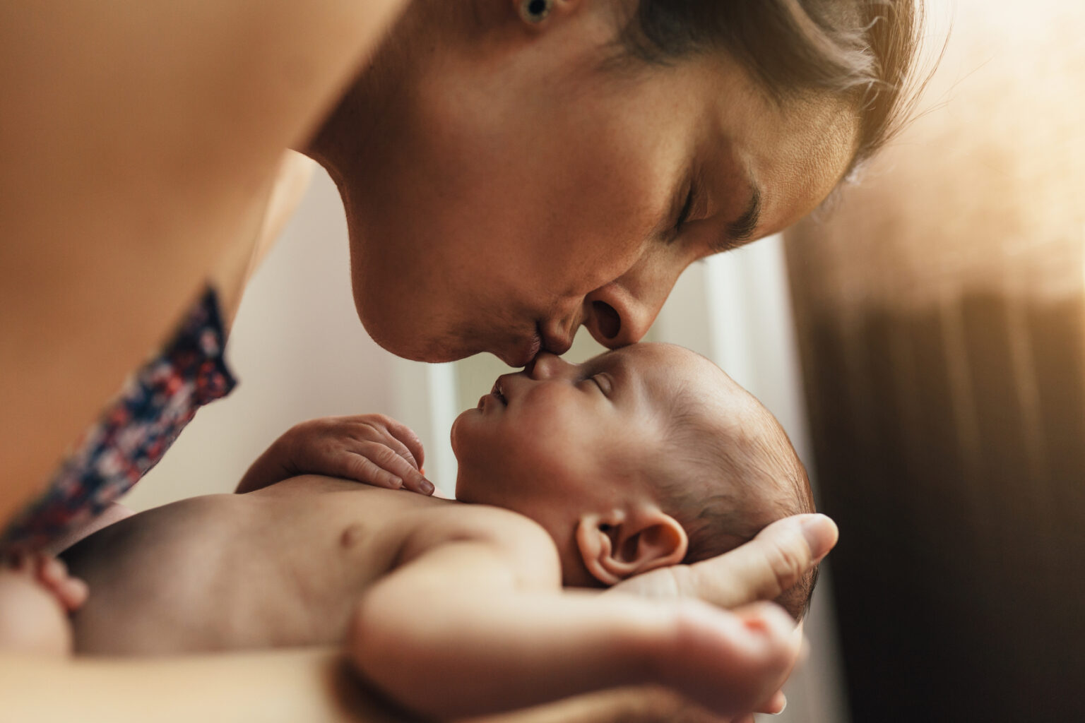 mom kissing baby